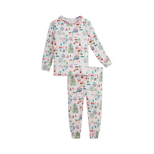 A two-piece children's pajama set featuring a long-sleeve top and matching pants with an all-over Christmas village print on a white background.