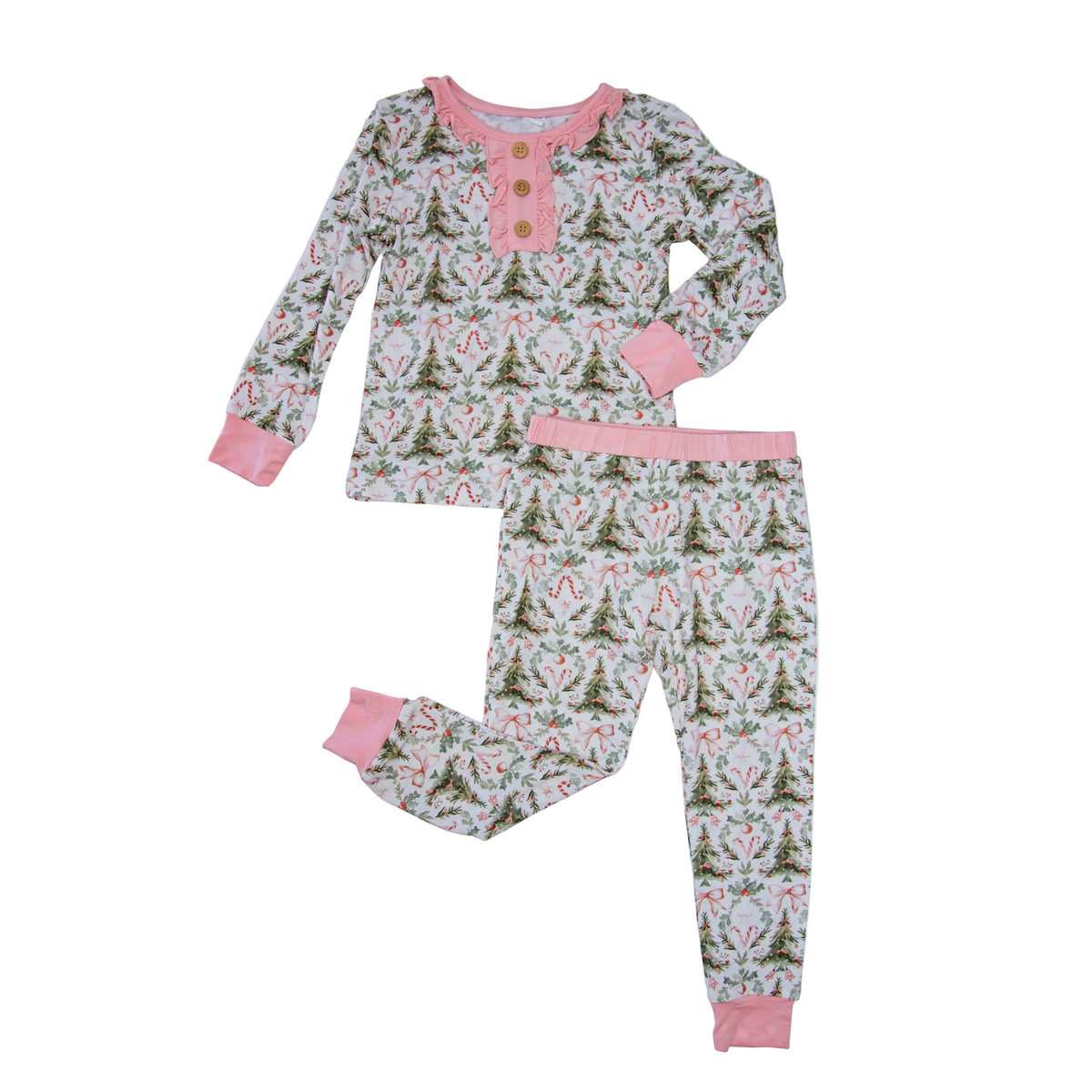 A two-piece children's pajama set laid flat on a light gray background. The set includes a long-sleeve henley top and matching pants, both featuring a repeating Christmas tree and snowflake pattern on a white base, with pink trim and cuffs.