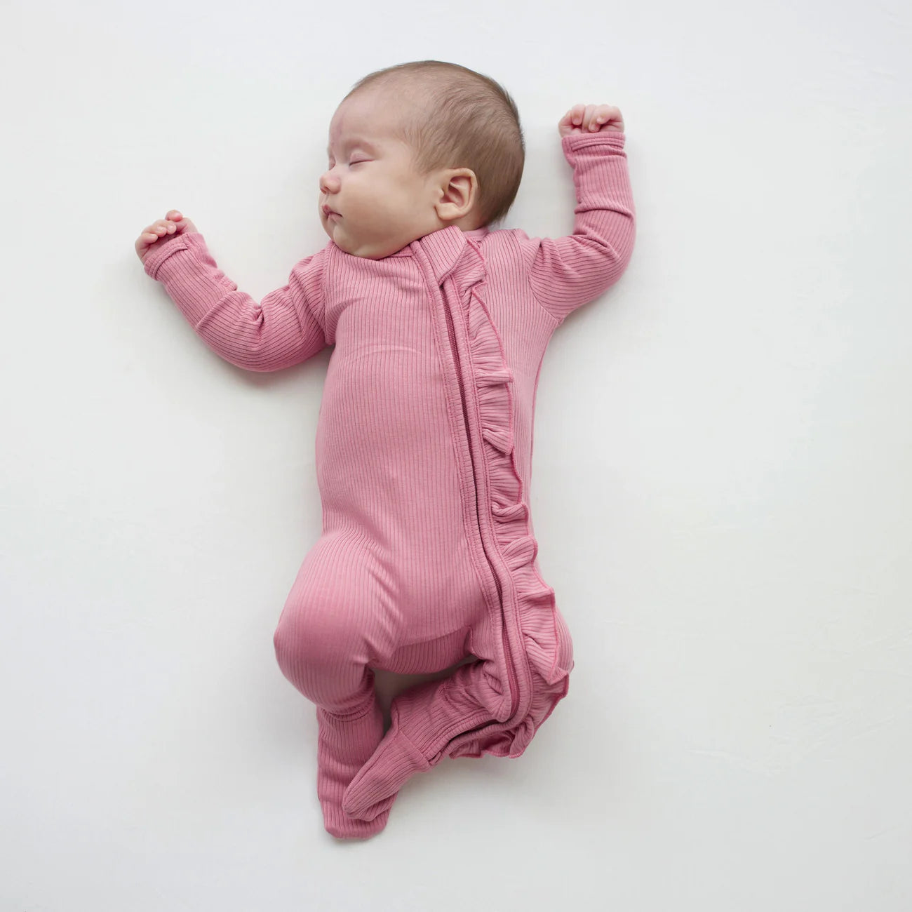 Kyte Baby Ribbed Ruffle Zippered Footie / Apple Blossom