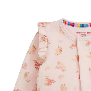 Baby outfit with floral pattern and colorful trim on a white background